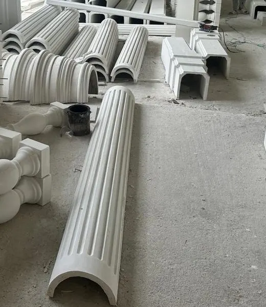 Half-round fluted GRC column shells lying on the factory floor